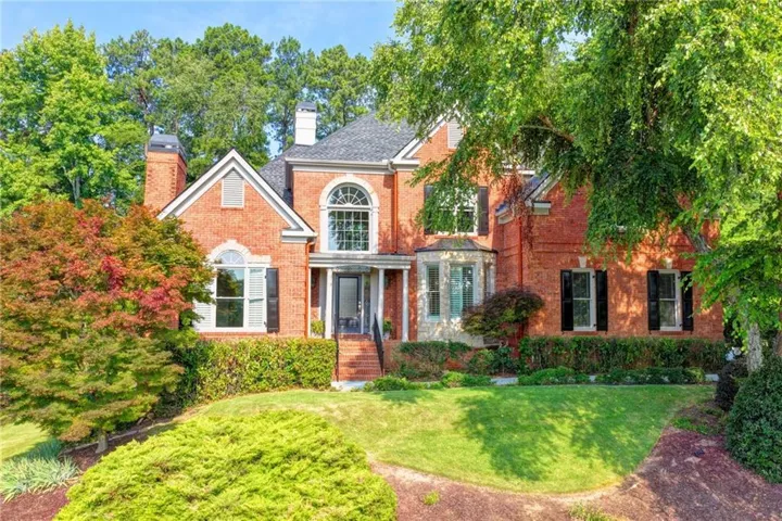 Red brick exterior featuring a multi-gable roofline and numerous windows