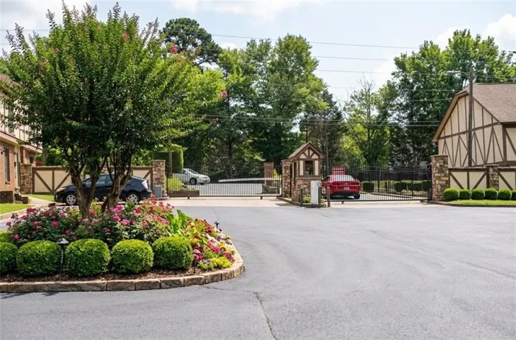Gated entry with stone columns and wrought iron fencing