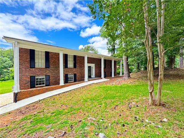 Brick exterior with a prominent portico featuring white columns