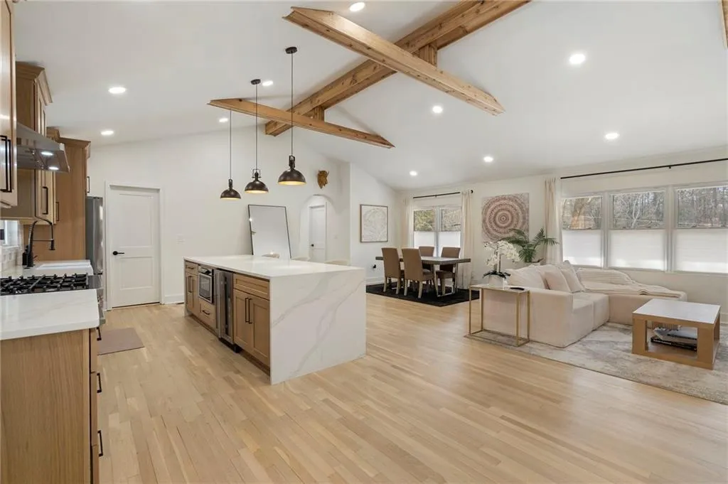Dining room featuring light wood-type flooring, recessed lighting, and a lit fireplace