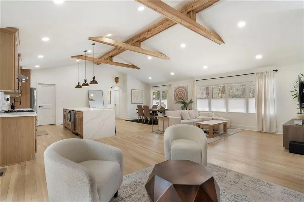 Kitchen with a breakfast bar, light wood-style flooring, french doors, a center island, and stainless steel fridge