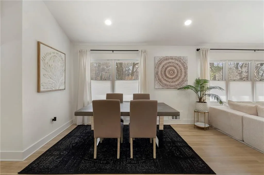Dining space with light wood-style floors, healthy amount of natural light, and recessed lighting