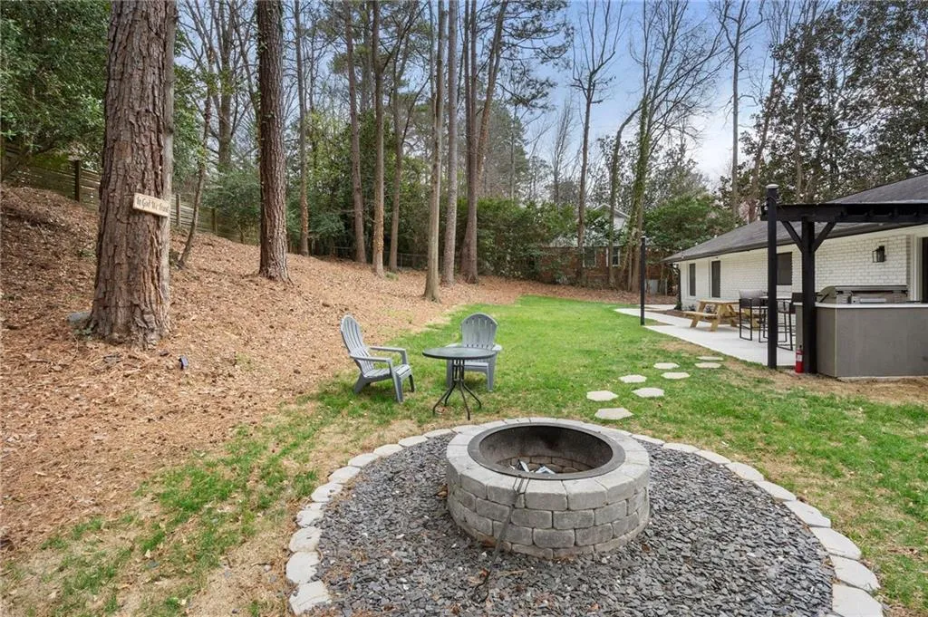 View of green lawn featuring a patio, an outdoor fire pit, and a pergola