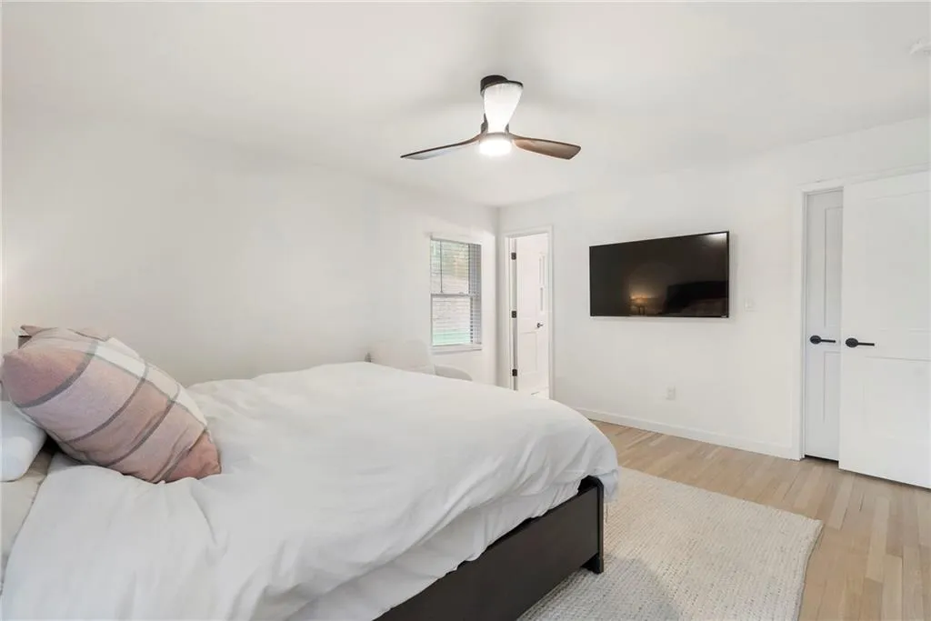Bedroom with light wood-type flooring and a ceiling fan