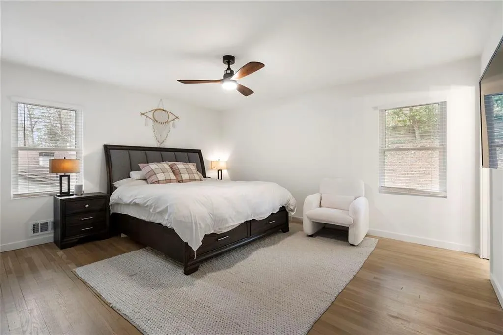 Bedroom with hardwood / wood-style flooring and ceiling fan
