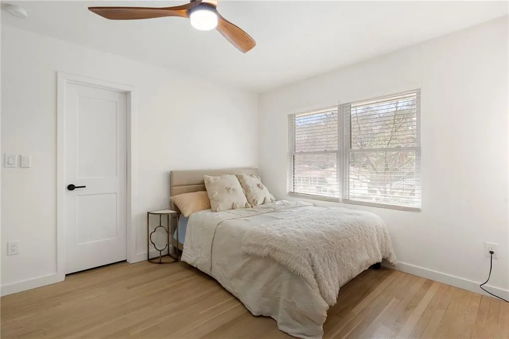 Bedroom with light wood-style flooring and a ceiling fan