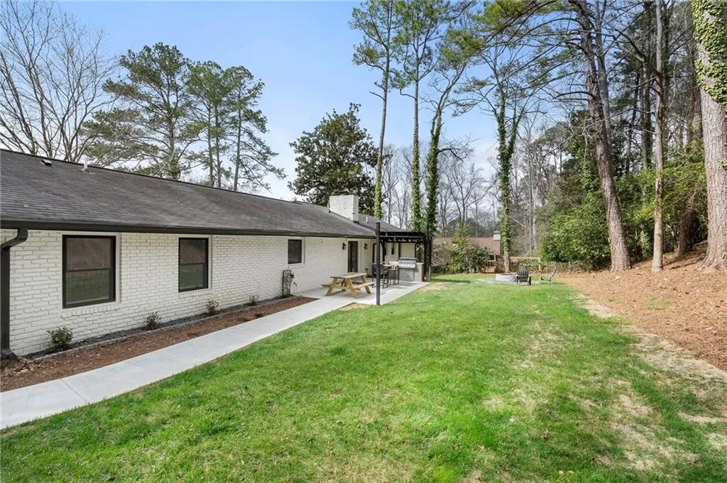 View of grassy yard featuring a patio area