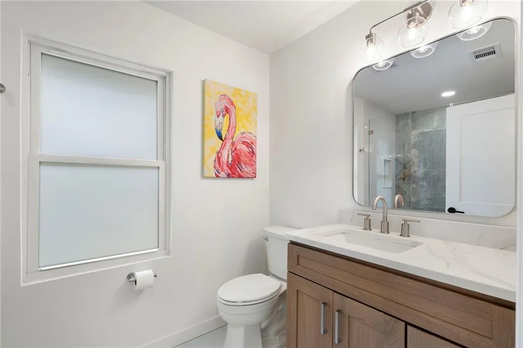 Full bath featuring vanity and a shower