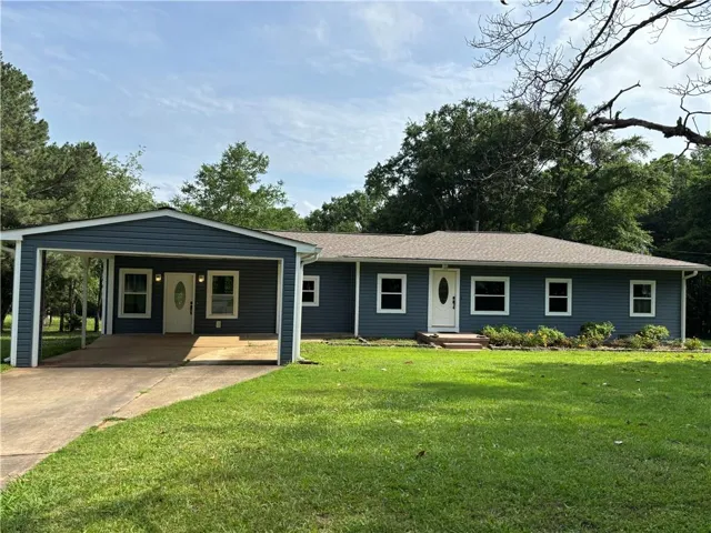 Ranch-style exterior with blue siding, white trim, and an attached carport