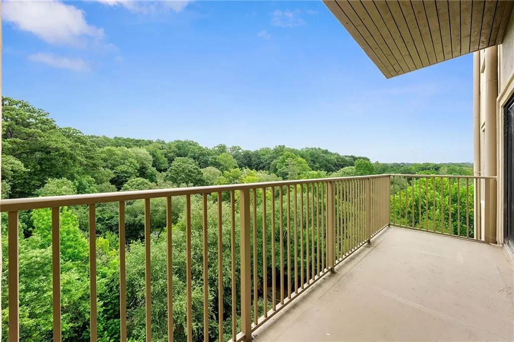 Balcony featuring a view of trees