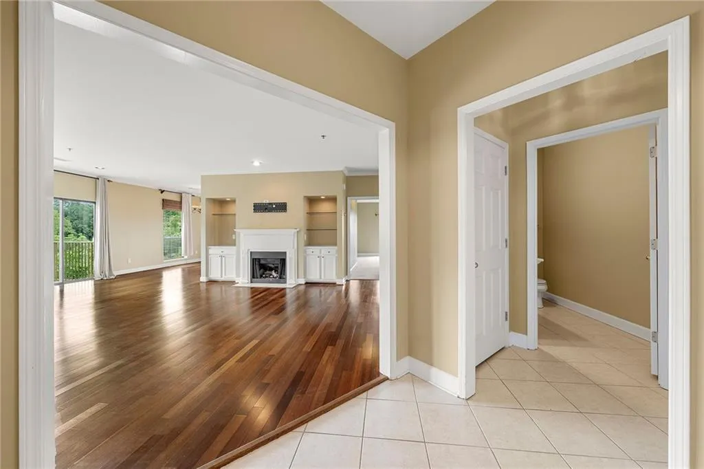 Unfurnished living room with a fireplace and light tile patterned flooring