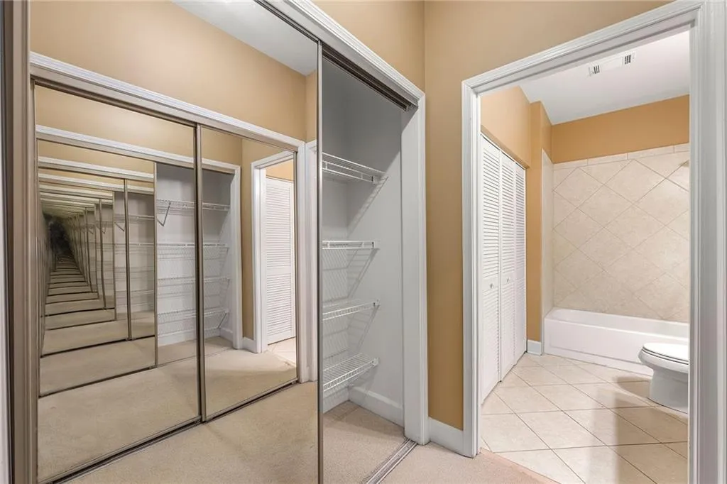 Full bathroom featuring a closet and light tile patterned flooring