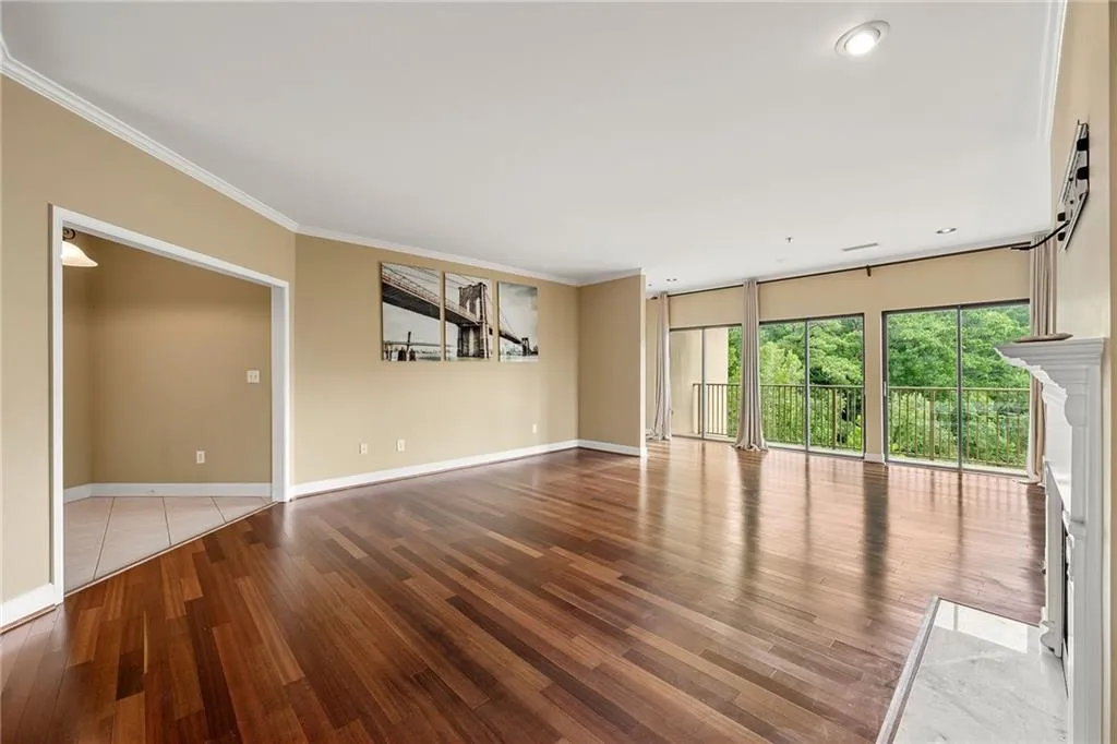 Unfurnished living room with ornamental molding, light wood-style flooring, and recessed lighting