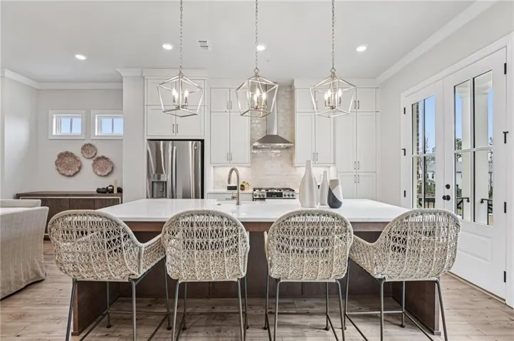 Kitchen featuring healthy amount of natural light and plenty of storage and seating