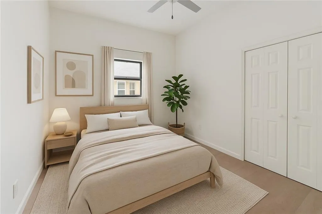 Bedroom with wood finished floors, ceiling fan, and a closet