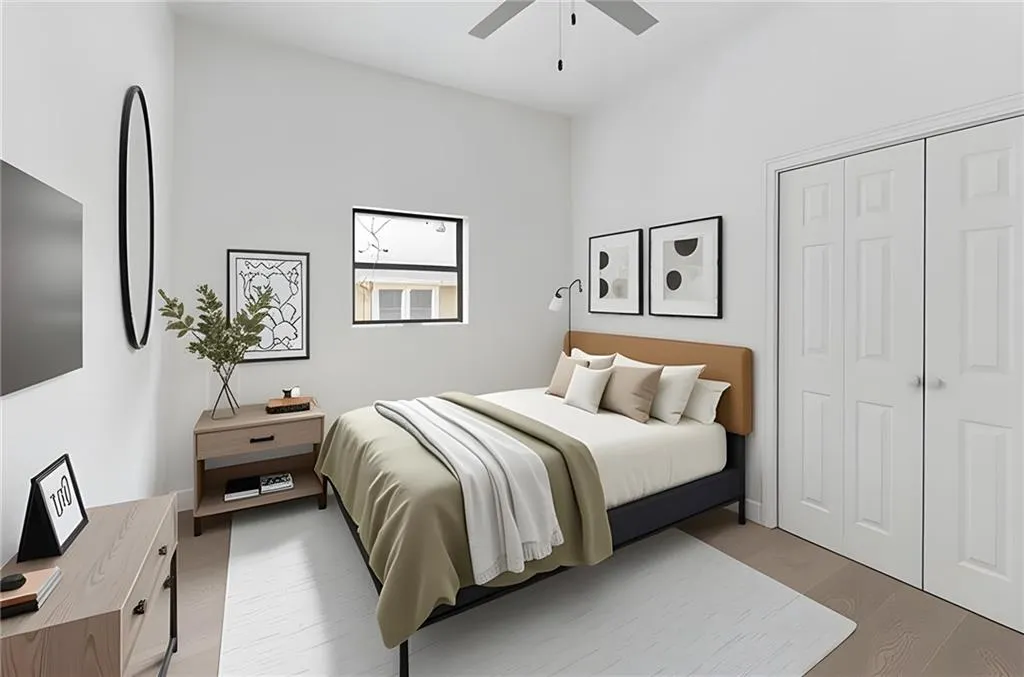 Bedroom featuring wood finished floors, a closet, and ceiling fan