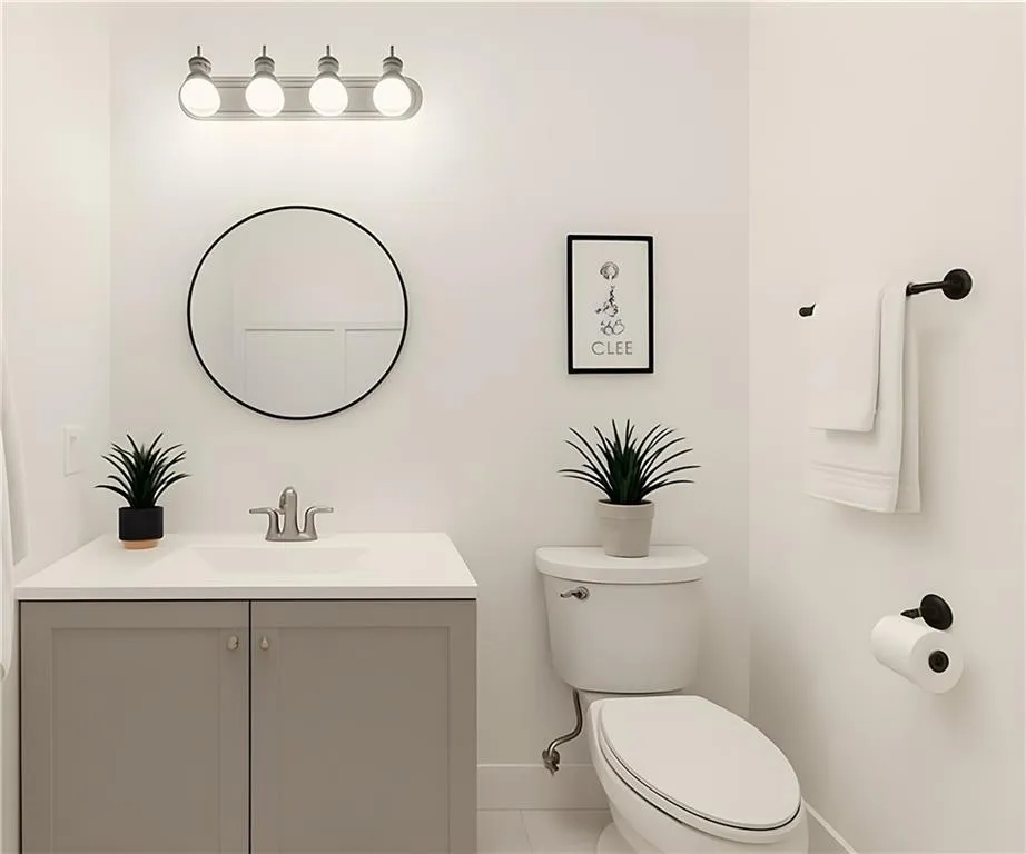 Half bath with vanity and tile patterned floors