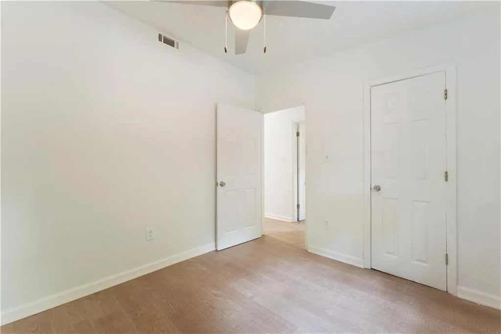 Unfurnished bedroom with light wood-style flooring and ceiling fan