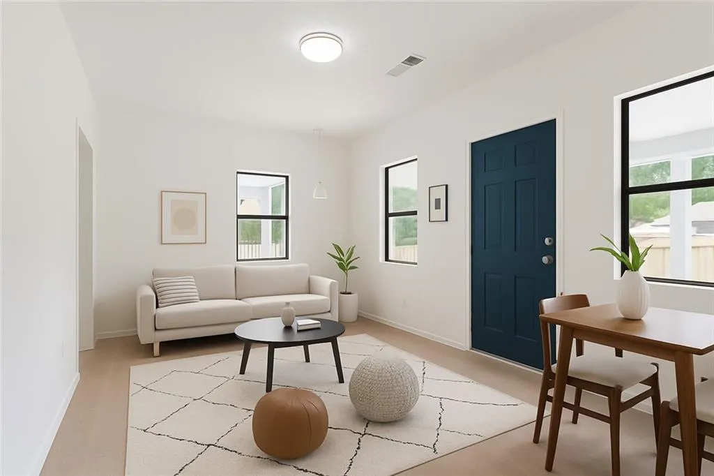 Living room with baseboards and light colored carpet