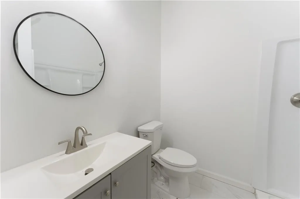 Half bathroom featuring vanity and toilet