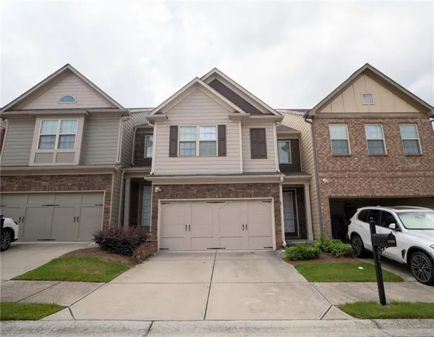 Charming brick and siding townhome community featuring three distinct architectural styles