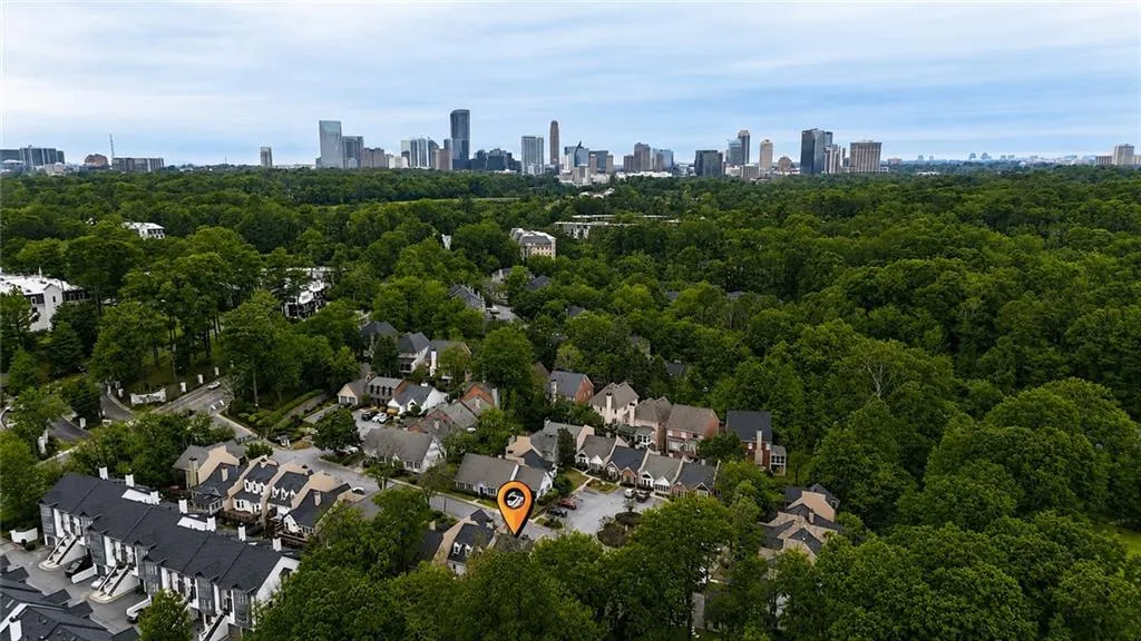 Aerial perspective showcasing a residential community surrounded by abundant mature trees