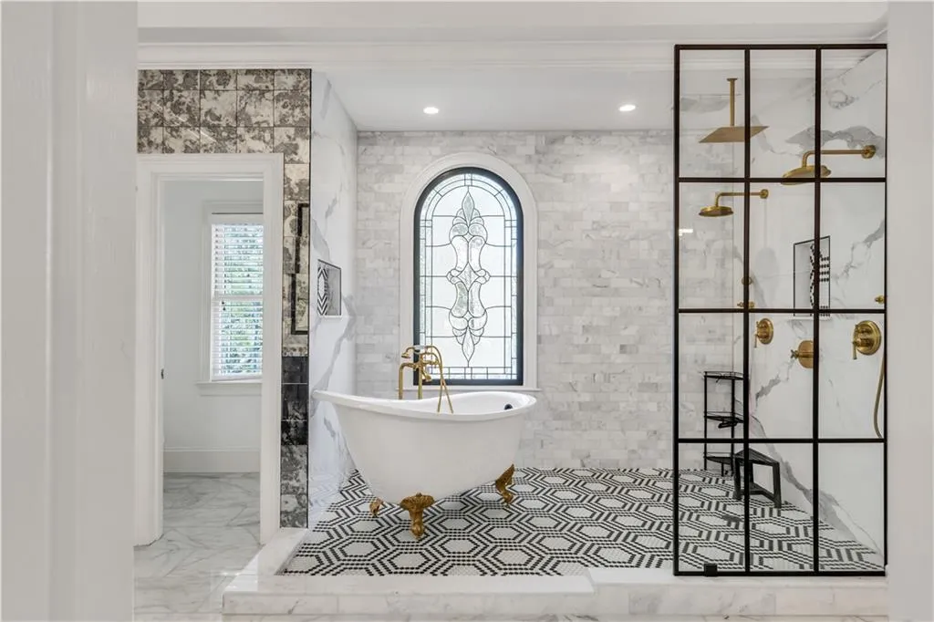 Bathroom featuring a soaking tub, walk in shower, light marble finish flooring, tile walls, and recessed lighting