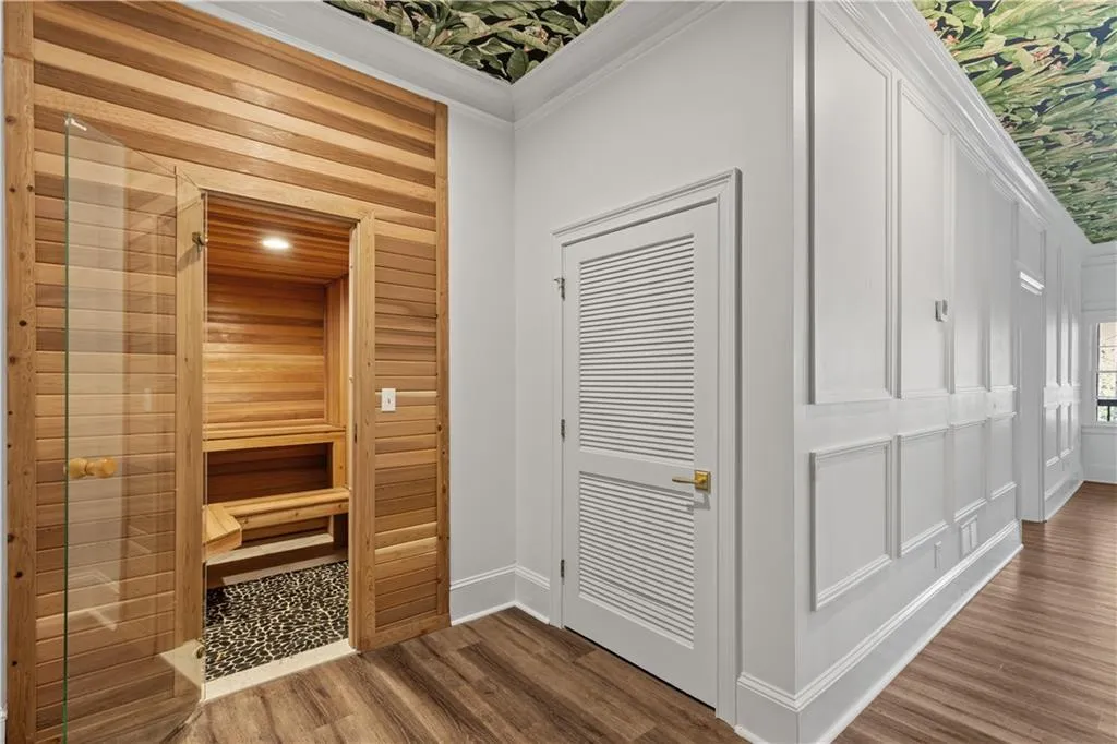 Sauna / steam room with wood finished floors and wooden walls