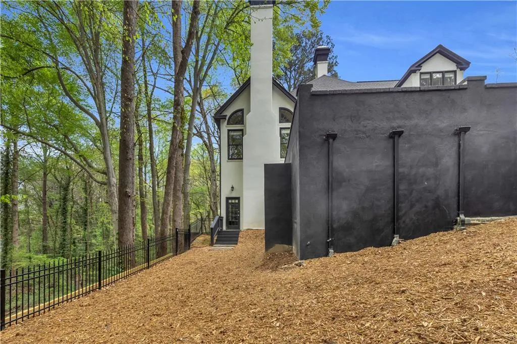 View of property exterior featuring a chimney and stucco siding