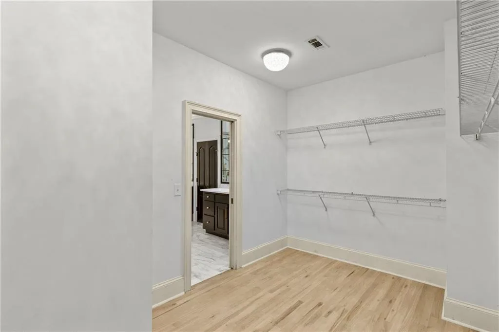 Walk in closet featuring light wood-style flooring