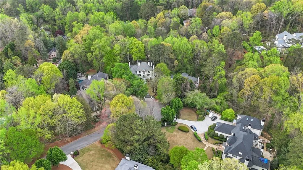 Aerial view of residential area featuring a heavily wooded area