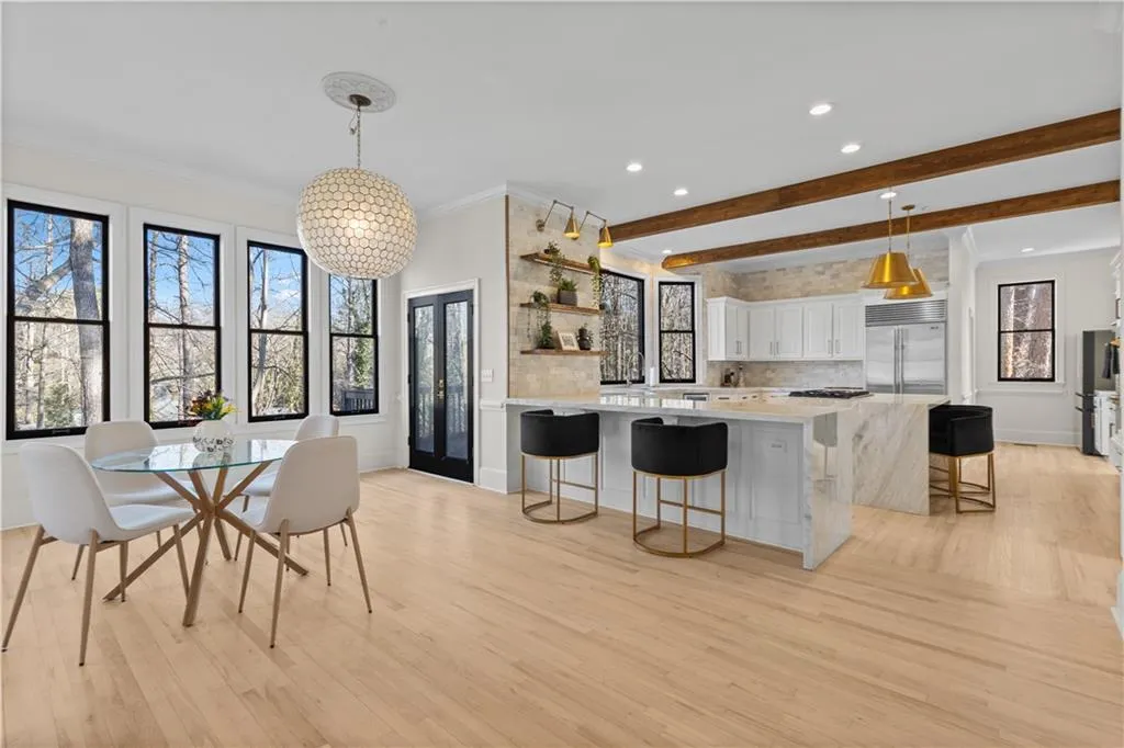 Dining area featuring crown molding, beamed ceiling, light wood finished floors, and recessed lighting