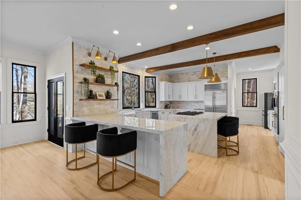 Kitchen featuring a breakfast bar, light wood-style flooring, crown molding, a peninsula, and open shelves