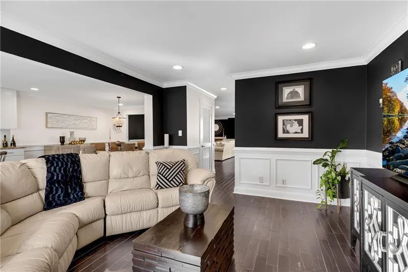 Living room with crown molding and french doors