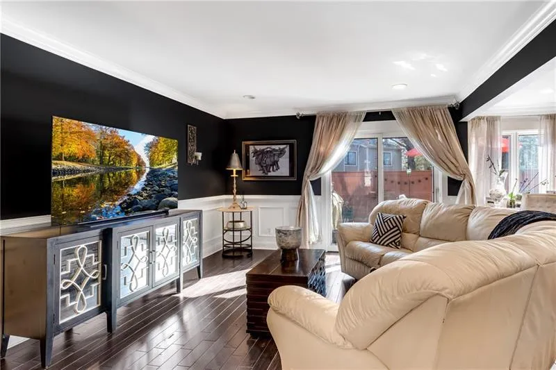 Living room with crown molding and french doors
