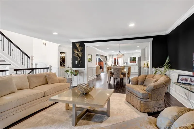 Living room with crown molding and hardwood flooring
