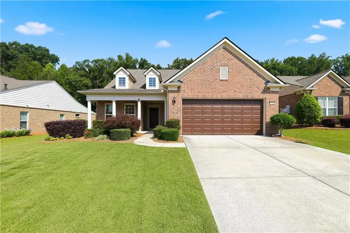 Brick exterior with a prominent two-car garage