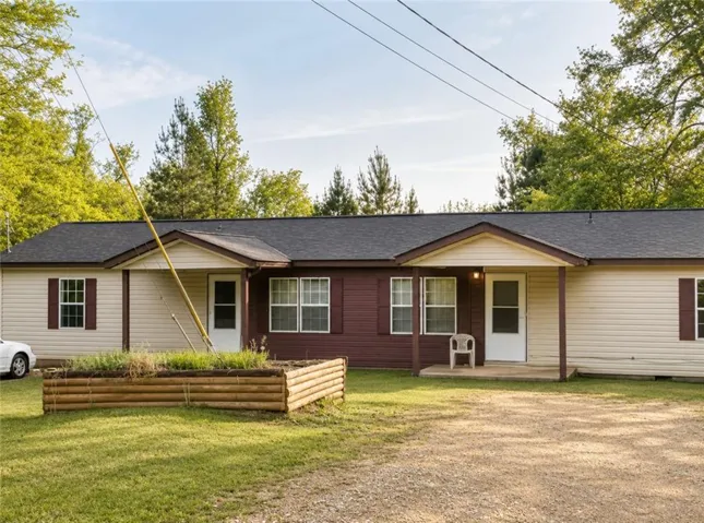 Two-tone siding exterior featuring a dark asphalt shingle roof