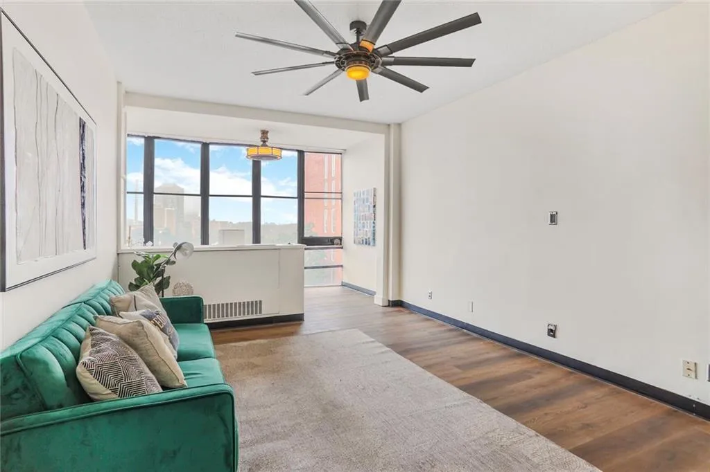 Living room featuring hardwood / wood-style floors and ceiling fan