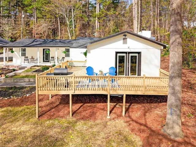 Elevated wood deck with railings, offering direct access via double glass doors