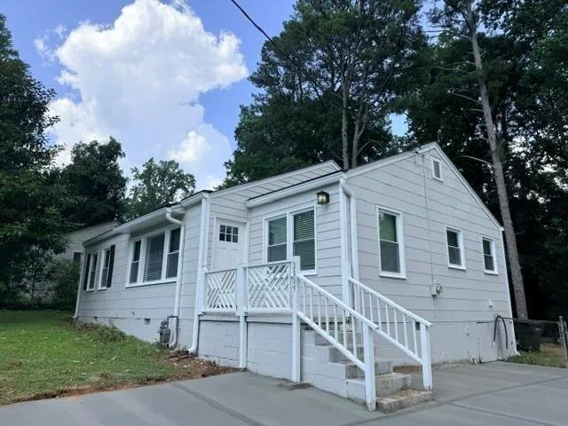 Light gray siding exterior with white trim and a gabled roof