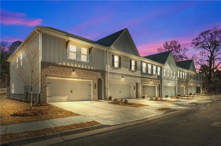 Townhome community featuring brick and vertical siding exteriors