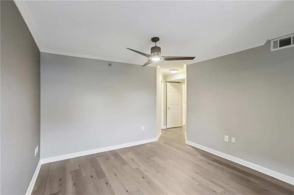 Spare room featuring ornamental molding, light hardwood / wood-style floors, and ceiling fan