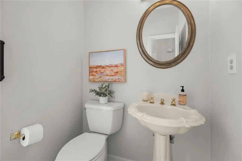 Just off the foyer is the private guest powder room / half bath.