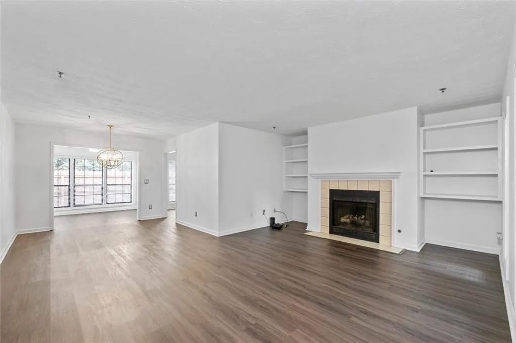 Enjoy this spacious living room with new LVP Flooring, built-in Bookshelves and Cozy fireplace with Gas Logs.