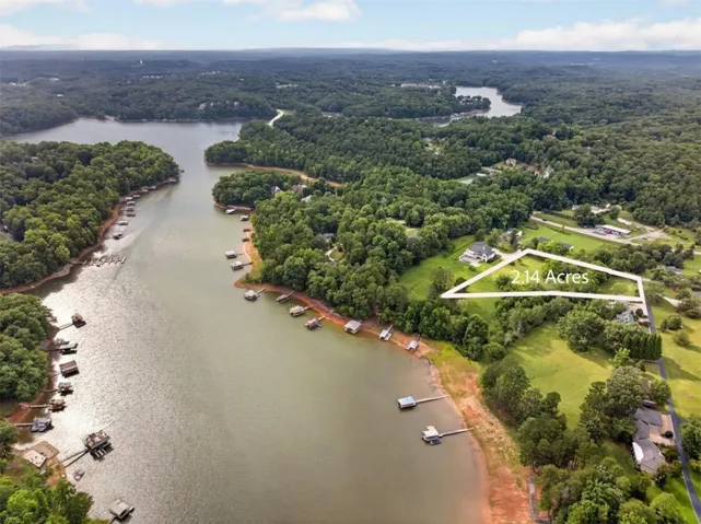 Expansive 2.14-acre property featuring ample green space and a partial tree-line border