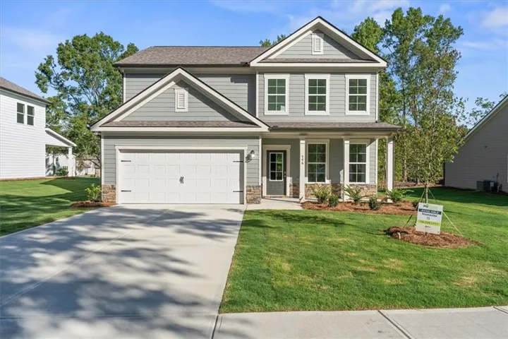 Contemporary two-story residence with a light gray siding exterior