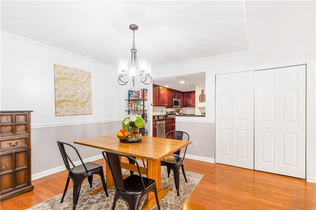 Dining room featuring hardwood / wood-style floors and a notable chandelier