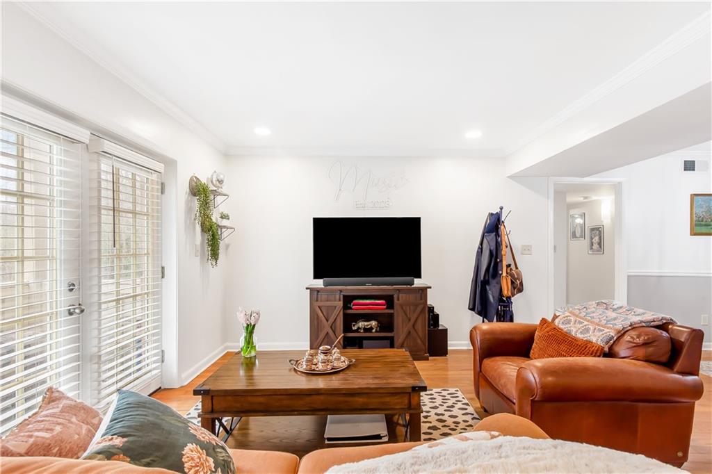 Living room featuring light hardwood / wood-style flooring and crown molding