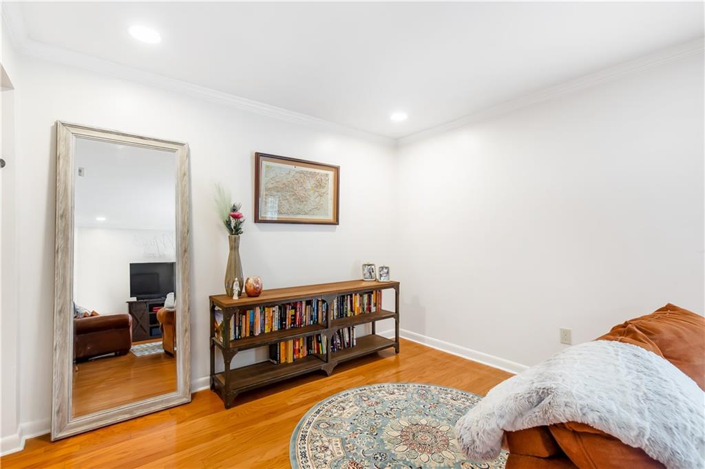 Living area featuring light hardwood / wood-style floors and crown molding